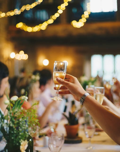People raising a glass at a wedding